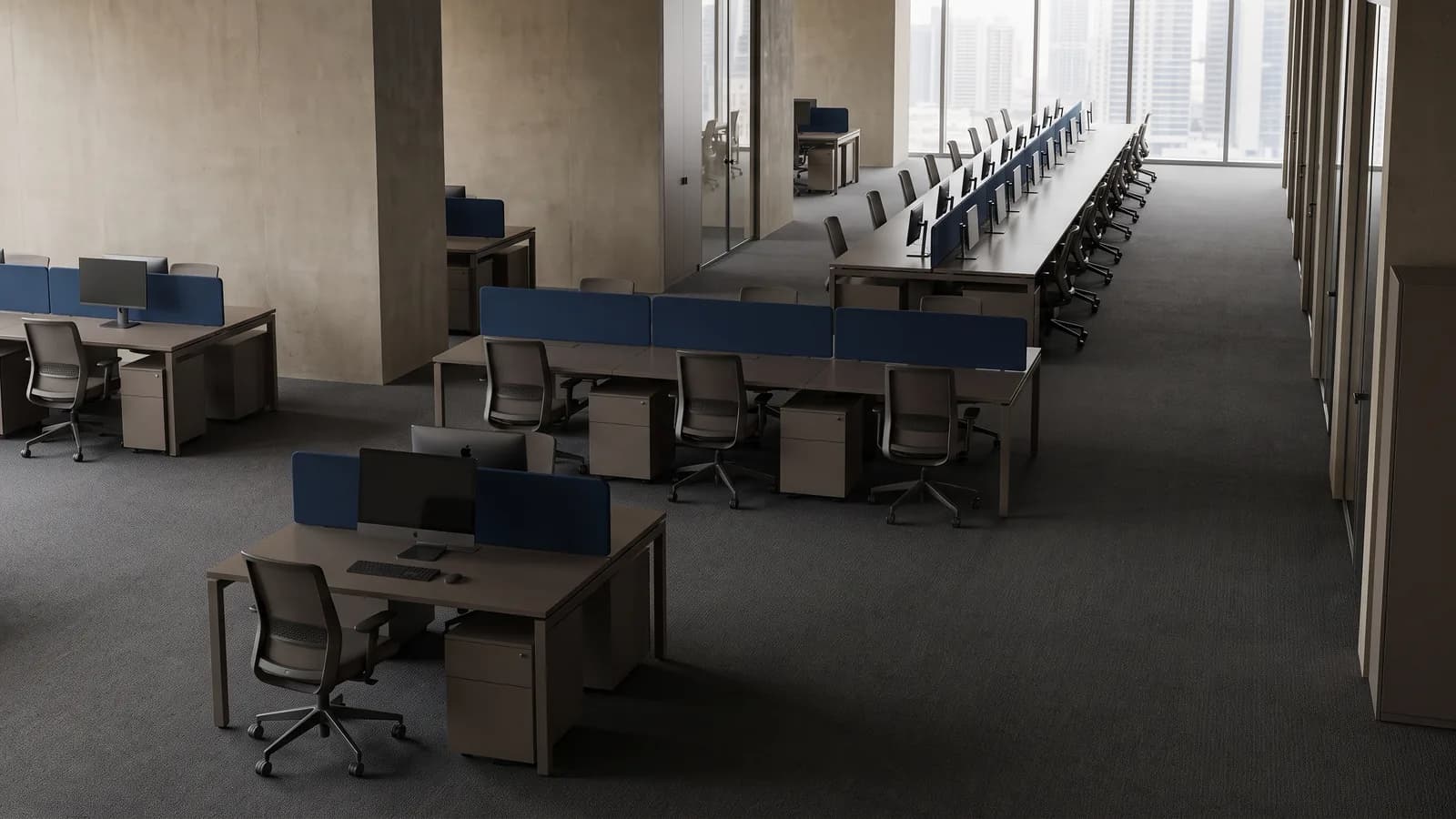Three groups of empty desks of increasing size receding through one Dubai office: a single desk, a cluster of five, and a long bank of many