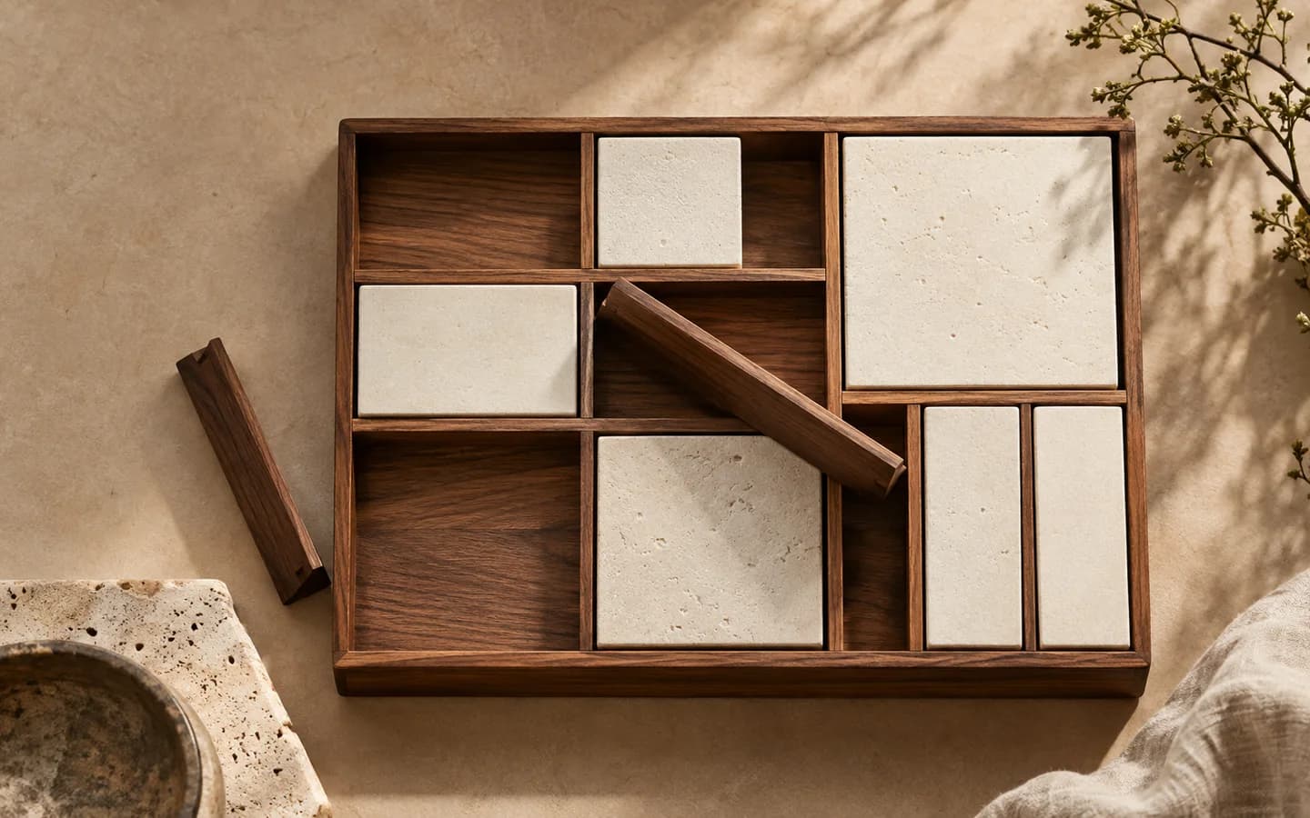 Adjustable walnut dividers and cream blocks form a custom desk organiser.