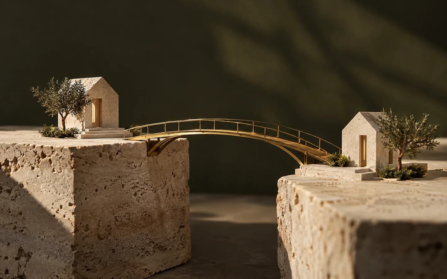 A brass bridge connects two stone platforms holding miniature houses.